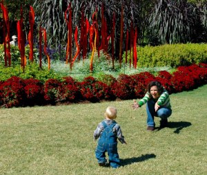 Levi runs to his mom in front of Chihuly exhibit